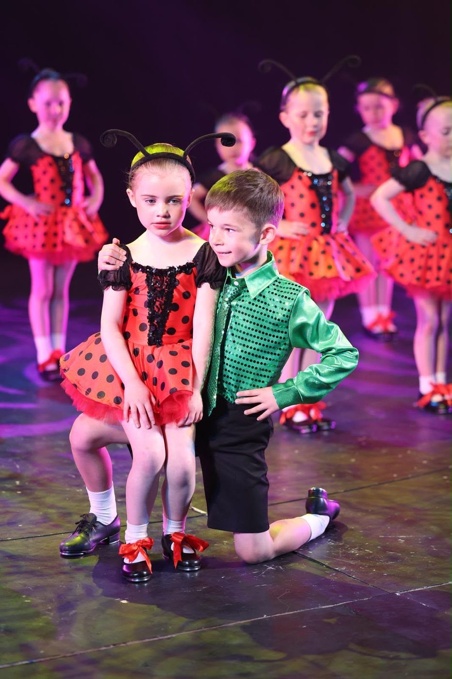 Two young dancers in ladybird-themed costumes
