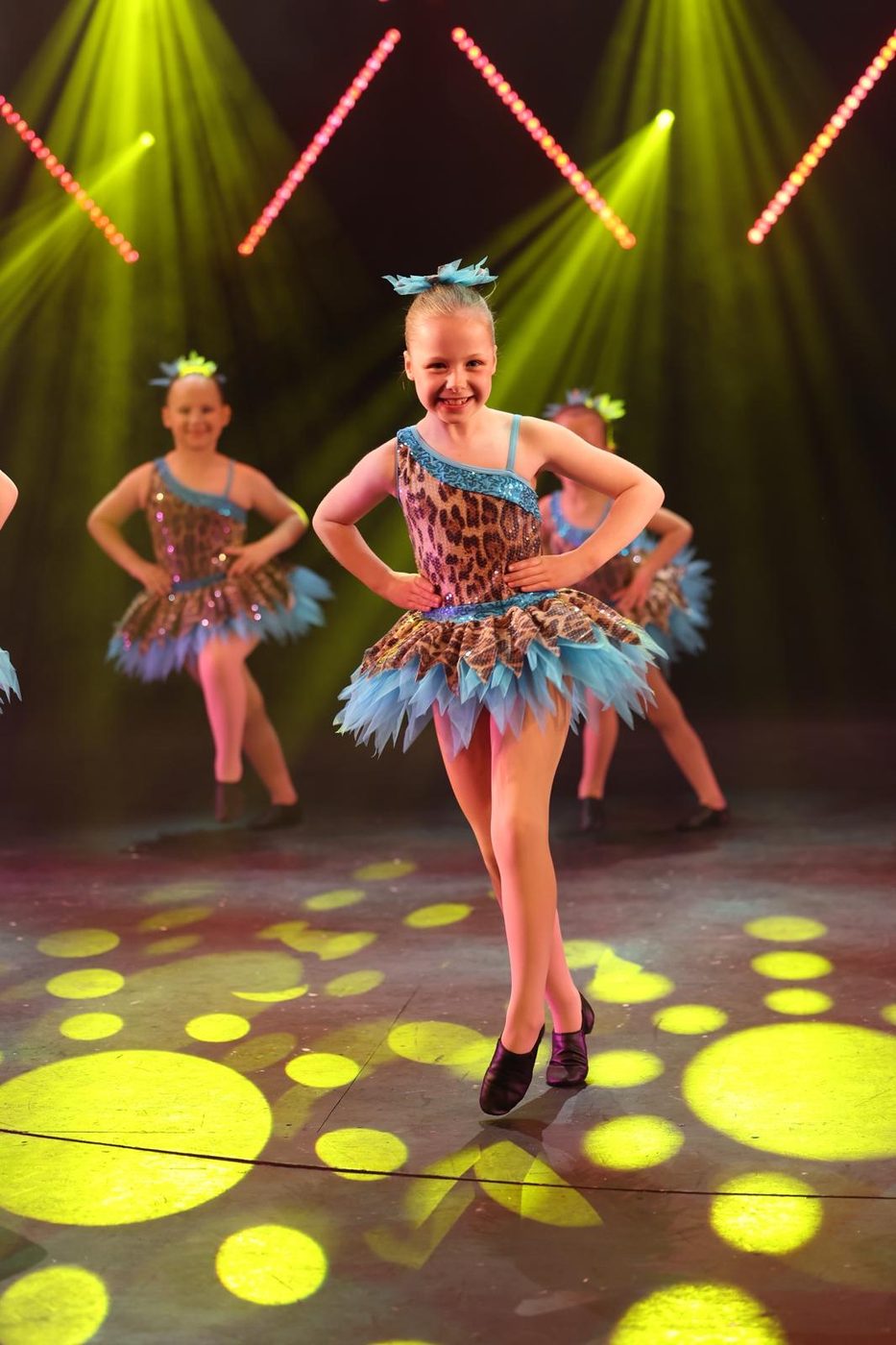 Young dancer in a leopard-print and blue feathered tutu