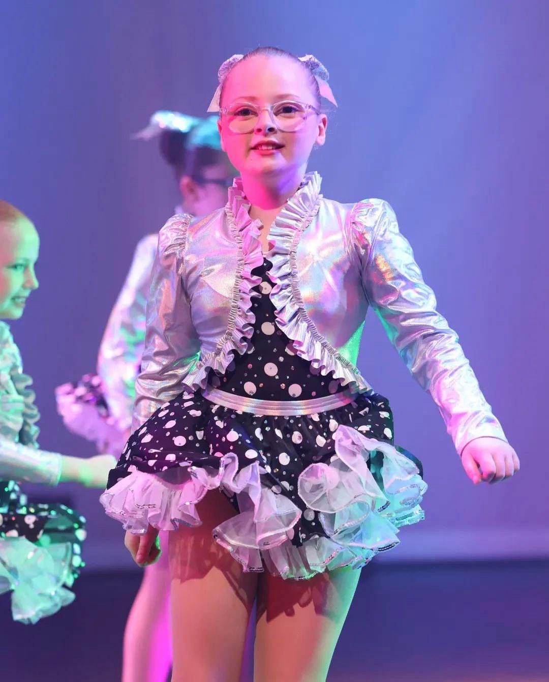 Dancer in a metallic silver costume performing on stage